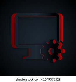 Paper cut Computer monitor and gear icon isolated on black background. Adjusting, service, setting, maintenance, repair, fixing. Paper art style. Vector Illustration