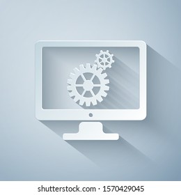Paper cut Computer monitor and gears icon on grey background. Monitor service concept. 