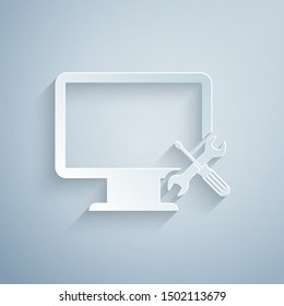 Paper cut Computer monitor with screwdriver and wrench icon isolated on grey background. Adjusting, service, setting, maintenance, repair, fixing. Paper art style. Vector Illustration