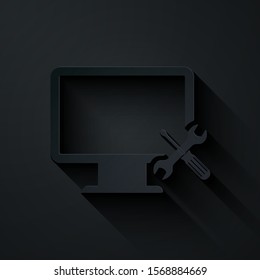 Paper cut Computer monitor with screwdriver and wrench icon isolated on black background. Adjusting, service, setting, maintenance, repair, fixing. Paper art style. Vector Illustration