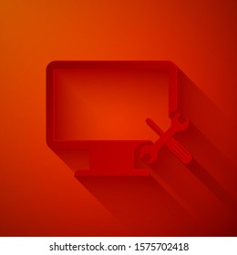 Paper cut Computer monitor with screwdriver and wrench icon isolated on red background. Adjusting, service, setting, maintenance, repair, fixing. Paper art style. Vector Illustration
