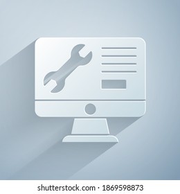 Paper cut Computer monitor with wrench icon isolated on grey background. Adjusting, service, setting, maintenance, repair. Paper art style. Vector