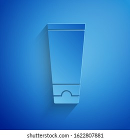 Paper cut Cream or lotion cosmetic tube icon isolated on blue background. Body care products for men. Paper art style. Vector Illustration