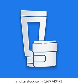 Paper cut Cream or lotion cosmetic tube icon isolated on blue background. Body care products for men. Paper art style. Vector Illustration