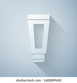 Paper cut Cream or lotion cosmetic tube icon isolated on grey background. Body care products for men. Paper art style. Vector Illustration