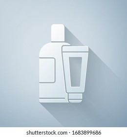 Paper cut Cream or lotion cosmetic tube icon isolated on grey background. Body care products for men. Paper art style. Vector Illustration