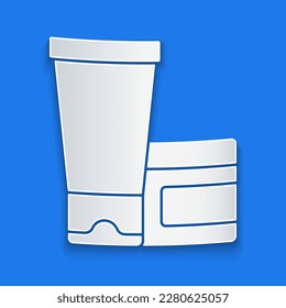 Paper cut Cream or lotion cosmetic tube icon isolated on blue background. Body care products for woman. Paper art style. Vector