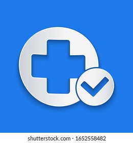 Paper cut Cross hospital medical icon isolated on blue background. First aid. Diagnostics symbol. Medicine and pharmacy sign. Paper art style. Vector Illustration