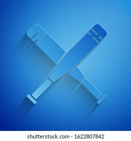 Paper cut Crossed baseball bat icon isolated on blue background. Paper art style. Vector Illustration