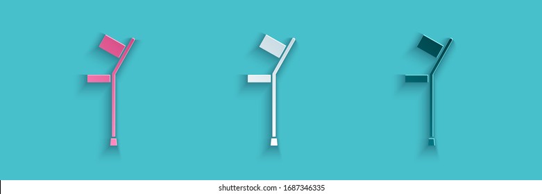 Paper cut Crutch or crutches icon isolated on blue background. Equipment for rehabilitation of people with diseases of musculoskeletal system. Paper art style. Vector Illustration