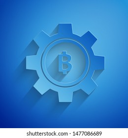 Paper cut Cryptocurrency coin Bitcoin icon isolated on blue background. Gear and Bitcoin setting. Blockchain based secure crypto currency. Paper art style. Vector Illustration