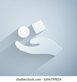 Paper cut Cube levitating above hand icon isolated on grey background. Levitation symbol. Paper art style. Vector Illustration