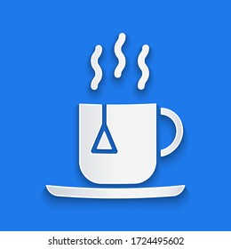 Paper cut Cup of tea with tea bag icon isolated on blue background. Paper art style. Vector Illustration