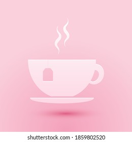 Paper cut Cup with tea bag icon isolated on pink background. Paper art style. Vector.