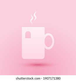 Paper cut Cup of tea with tea bag icon isolated on pink background. Paper art style. Vector.