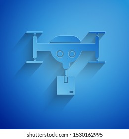 Paper cut Delivery drone with the package icon isolated on blue background. Drone delivering cardboard box. Paper art style. Vector Illustration