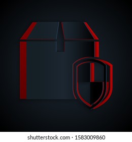 Paper cut Delivery pack security symbol with shield icon isolated on black background. Delivery insurance. Insured cardboard boxes beyond the shield. Paper art style. Vector Illustration