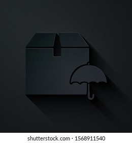 Paper cut Delivery package with umbrella symbol icon isolated on black background. Parcel cardboard box with umbrella sign. Logistic and delivery. Paper art style. Vector Illustration
