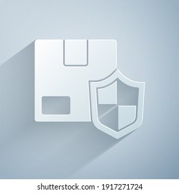 Paper cut Delivery security with shield icon isolated on grey background. Delivery insurance. Insured cardboard boxes beyond the shield. Paper art style. Vector