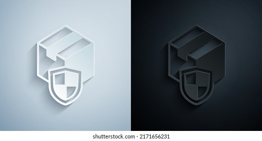 Paper cut Delivery security with shield icon isolated on grey and black background. Delivery insurance. Insured cardboard boxes beyond the shield. Paper art style. Vector