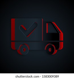 Paper cut Delivery truck with check mark icon isolated on black background. Paper art style. Vector Illustration