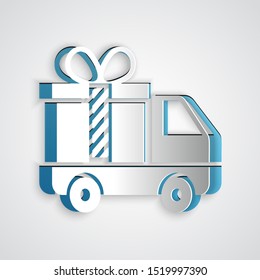 Paper cut Delivery truck with gift icon isolated on grey background. Paper art style. Vector Illustration