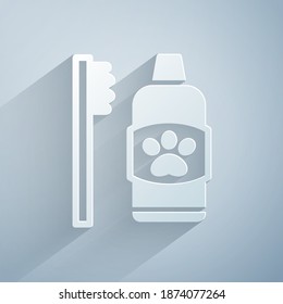 Paper cut Dental hygiene for pets icon isolated on grey background. Toothbrush and toothpaste. Teeth cleaning. Paper art style. Vector