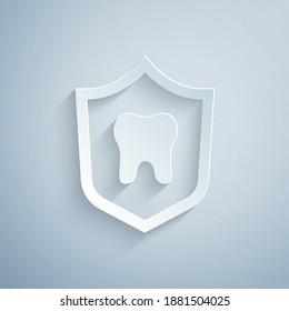 Paper cut Dental protection icon isolated on grey background. Tooth on shield logo. Paper art style. Vector.