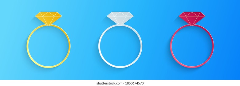 Recorte de papel Icono del anillo de compromiso de diamantes aislado en fondo azul. Estilo de arte de papel. Vector.