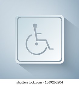 Paper cut Disabled handicap icon isolated on grey background. Wheelchair handicap sign. Paper art style. Vector Illustration