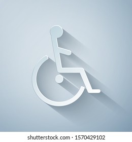 Paper cut Disabled handicap icon isolated on grey background. Wheelchair handicap sign. Paper art style. Vector Illustration