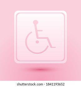 Paper cut Disabled handicap icon isolated on pink background. Wheelchair handicap sign. Paper art style. Vector.