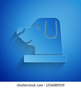 Paper cut Dog in astronaut helmet icon isolated on blue background. Paper art style. Vector Illustration