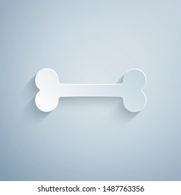 Paper cut Dog bone icon isolated on grey background. Pets food symbol. Paper art style. Vector Illustration