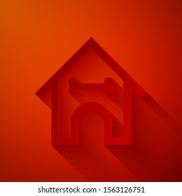 Paper cut Dog house and bone icon isolated on red background. Dog kennel. Paper art style. Vector Illustration