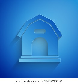 Paper cut Dog house icon isolated on blue background. Dog kennel. Paper art style. Vector Illustration