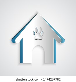 Paper cut Dog house and paw print pet icon isolated on grey background. Dog kennel. Paper art style. Vector Illustration