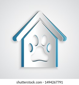 Paper cut Dog house and paw print pet icon isolated on grey background. Dog kennel. Paper art style. Vector Illustration