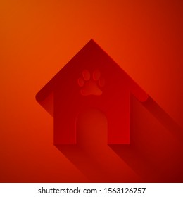 Paper cut Dog house and paw print pet icon isolated on red background. Dog kennel. Paper art style. Vector Illustration