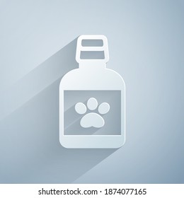 Paper cut Dog medicine bottle icon isolated on grey background. Container with pills. Prescription medicine for animal. Paper art style. Vector