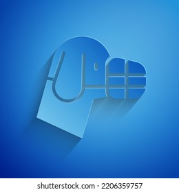 Paper cut Dog in muzzle icon isolated on blue background. Accessory for dog. Paper art style. Vector