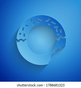 Paper cut Donut with sweet glaze icon isolated on blue background. Paper art style. Vector