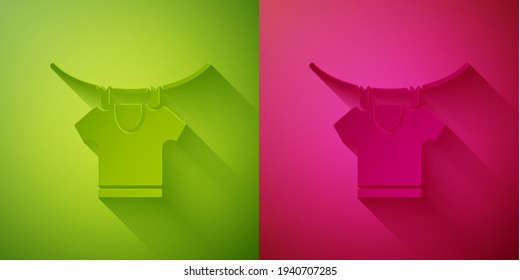 Paper cut Drying clothes icon isolated on green and pink background. Clean shirt. Wash clothes on a rope with clothespins. Clothing care and tidiness. Paper art style. Vector