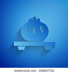 Paper cut Dumpling on cutting board icon isolated on blue background. Traditional chinese dish. Paper art style. Vector Illustration