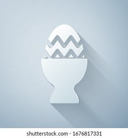 Paper cut Easter egg on a stand icon isolated on grey background. Happy Easter. Paper art style. Vector Illustration