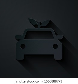 Paper cut Eco car concept drive with leaf icon isolated on black background. Green energy car symbol. Paper art style. Vector Illustration