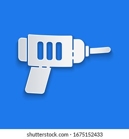 Paper cut Electric drill machine icon isolated on blue background. Repair tool. Paper art style. Vector Illustration