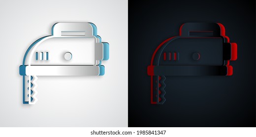 Paper cut Electric jigsaw with steel sharp blade icon isolated on grey and black background. Power tool for woodwork. Paper art style. Vector