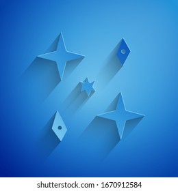 Paper cut Falling stars icon isolated on blue background. Meteoroid, meteorite, comet, asteroid, star icon. Paper art style. Vector Illustration