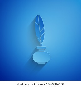 Paper cut Feather and inkwell icon isolated on blue background. Paper art style. Vector Illustration